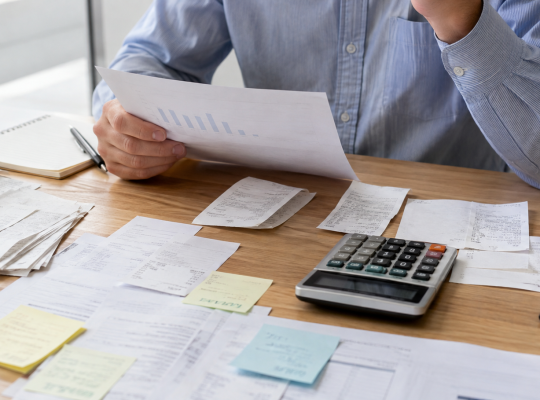 Business reviewer comparing an income story with receipts and expenses